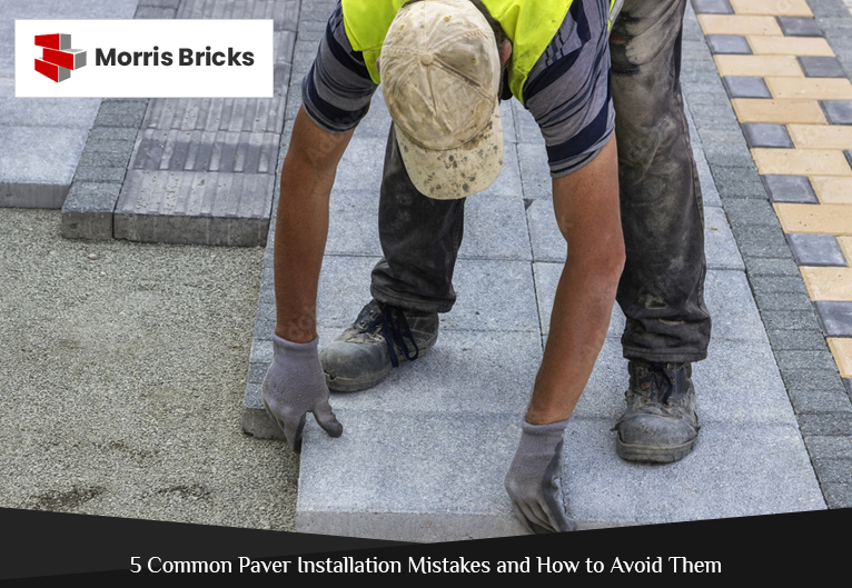 Workers preparing the base for paver installation