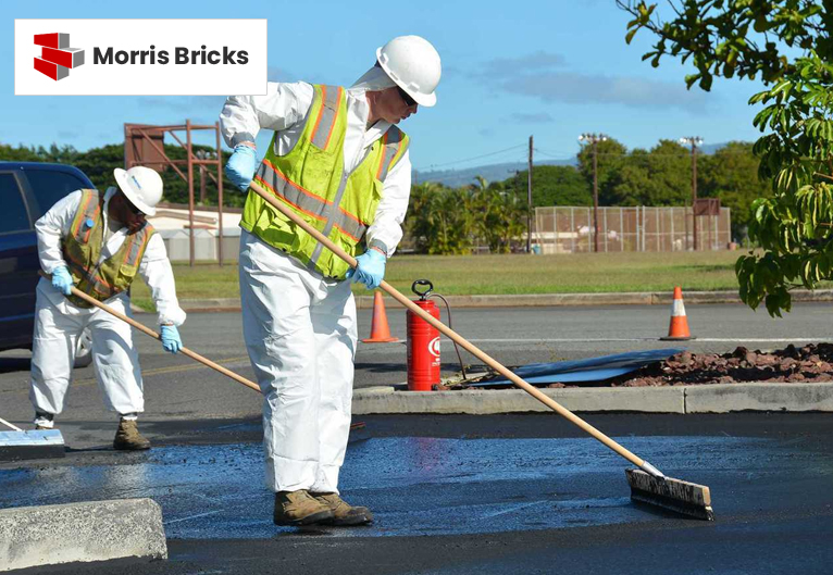 Worker installing pavers on a residential driveway